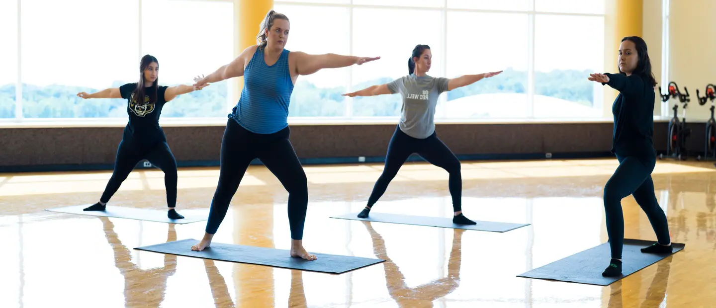 Students taking a yoga class in a studio